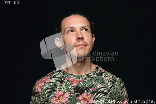 Image of Close up portrait of young man isolated on black studio background