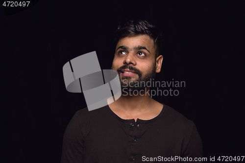 Image of Close up portrait of young man isolated on black studio background