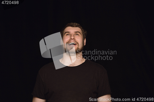 Image of Close up portrait of young man isolated on black studio background