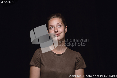 Image of Close up portrait of young woman isolated on black studio background