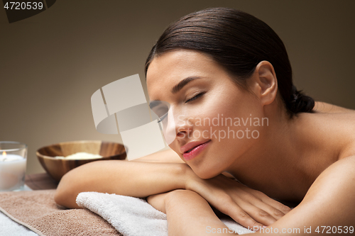 Image of young woman lying at spa or massage parlor