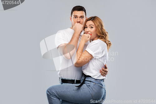 Image of scared couple in white t-shirts