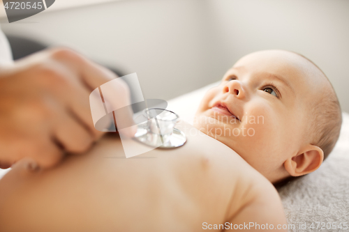 Image of doctor with stethoscope listening to baby patient