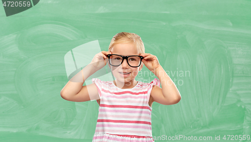 Image of smiling cute little girl in glasses at school