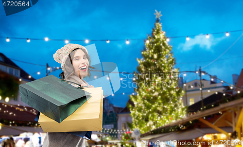 Image of woman with shopping bags at christmas market