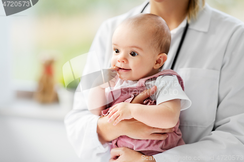 Image of female pediatrician doctor with baby at clinic