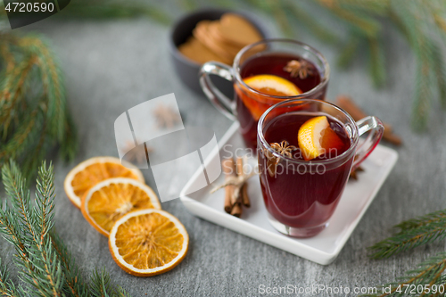 Image of mulled wine, orange slices, gingerbread and spices