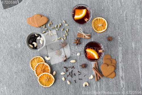 Image of hot mulled wine, orange slices, raisins and spices