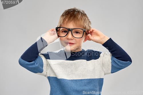 Image of portrait of smiling little boy in glasses