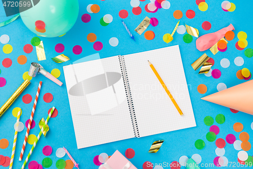 Image of notebook with pencil and birthday party props