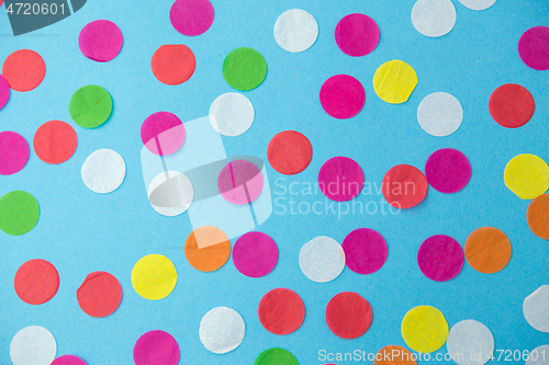 Image of colorful confetti decoration on blue background