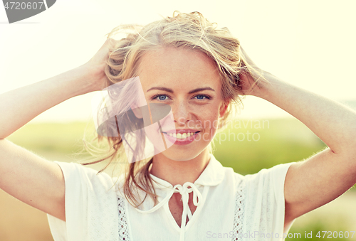 Image of close up of happy young woman in white outdoors