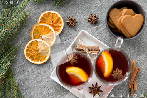 Image of mulled wine, orange slices, gingerbread and spices