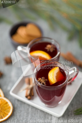 Image of mulled wine, orange slices, gingerbread and spices