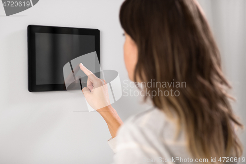 Image of woman using tablet computer at smart home