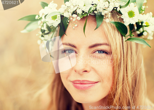 Image of happy woman in wreath of flowers