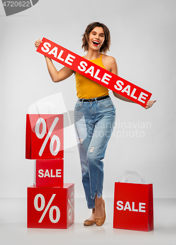 Image of happy smiling young woman with shopping bags