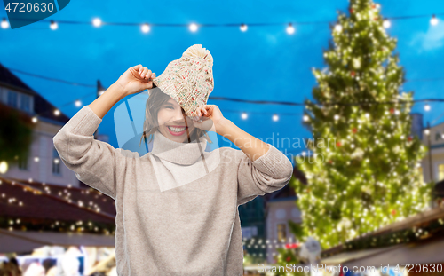 Image of woman in hat and sweater at christmas market