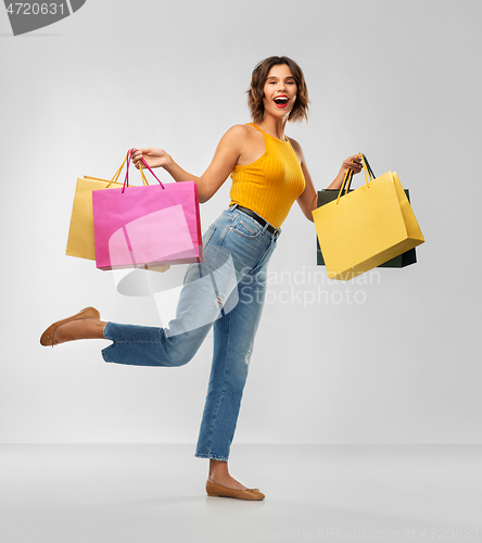 Image of happy smiling young woman with shopping bags