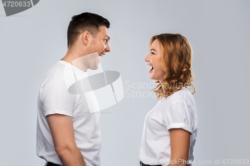 Image of portrait of laughinh couple in white t-shirts