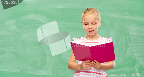 Image of smiling little girl reading book at school