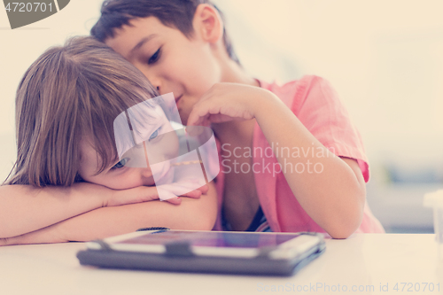 Image of cute little brother and sister having fun at home