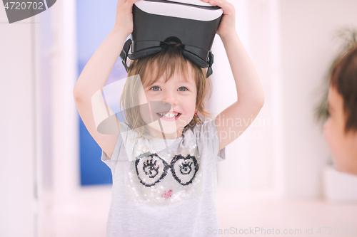 Image of little girl at home wearing vr glasses