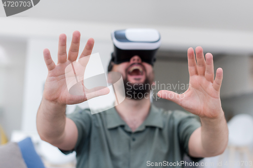 Image of man with beard trying vr glasses