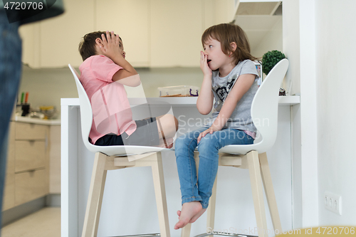 Image of cute little brother and sister at home