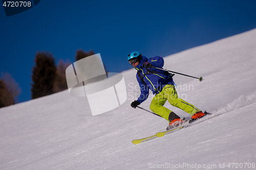 Image of Skier having fun while running downhill