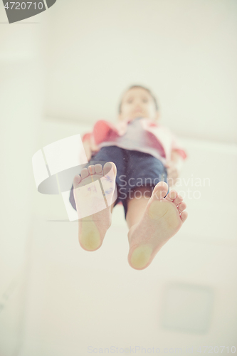 Image of little boy standing on transparent glass floor