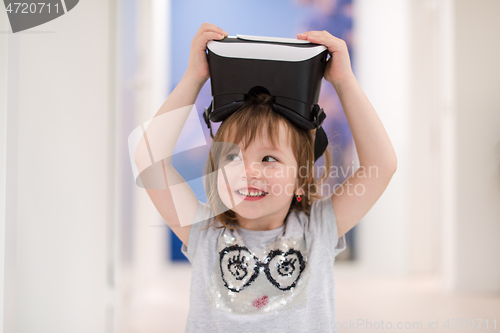 Image of little girl at home wearing vr glasses