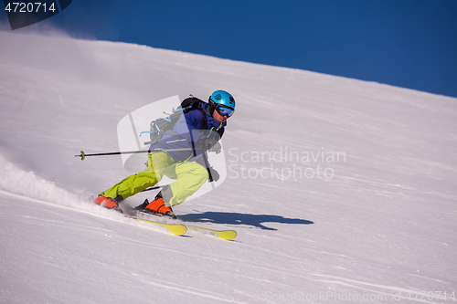 Image of Skier having fun while running downhill