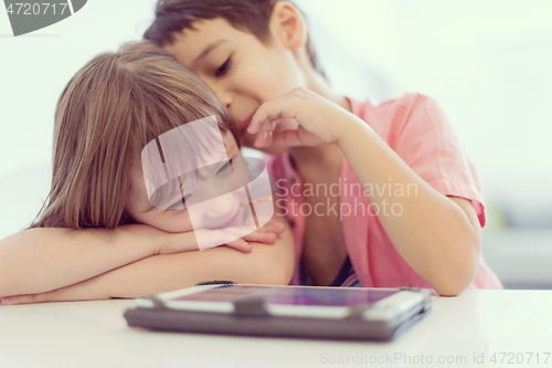 Image of cute little brother and sister having fun at home