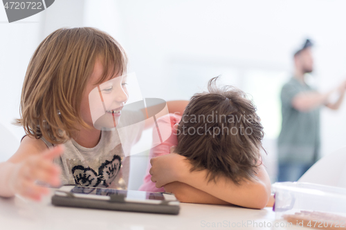 Image of cute little brother and sister having fun at home