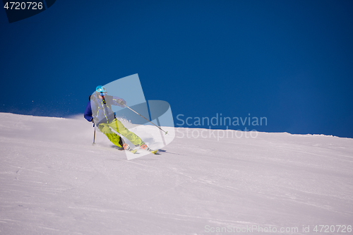 Image of Skier having fun while running downhill