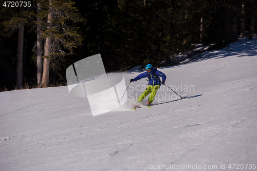 Image of Skier having fun while running downhill