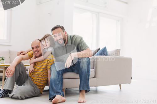 Image of Portrait of male gay couple with adopted childre