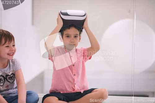 Image of kids using virtual reality headsets at home