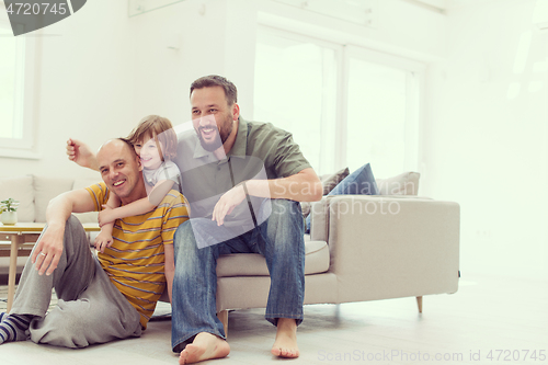 Image of Portrait of male gay couple with adopted childre