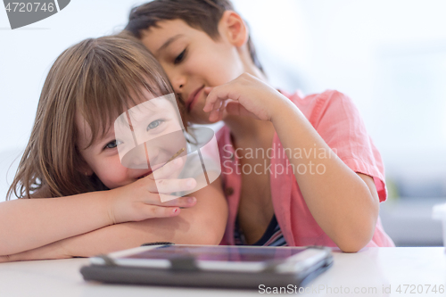 Image of cute little brother and sister having fun at home