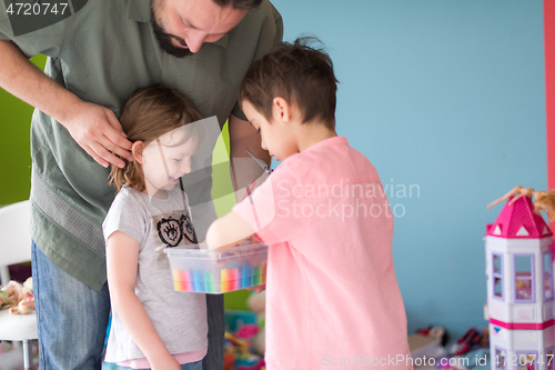 Image of sister and brother havin fun and play hairstylist game at home