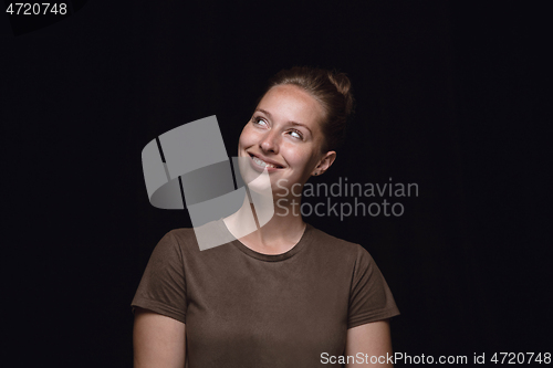 Image of Close up portrait of young woman isolated on black studio background