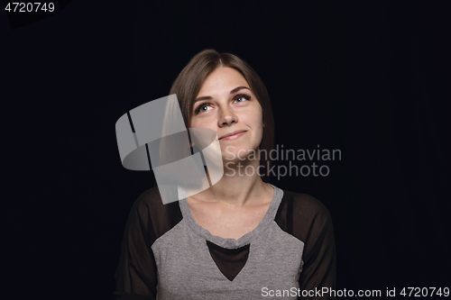 Image of Close up portrait of young woman isolated on black studio background