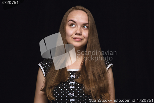 Image of Close up portrait of young woman isolated on black studio background