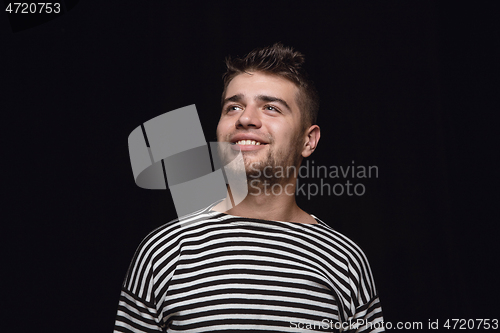 Image of Close up portrait of young man isolated on black studio background