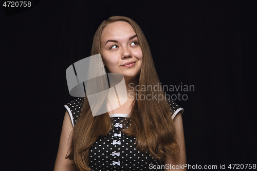 Image of Close up portrait of young woman isolated on black studio background