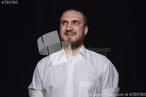 Image of Close up portrait of young man isolated on black studio background