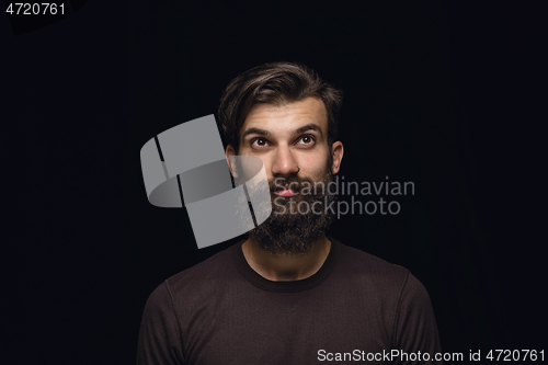 Image of Close up portrait of young man isolated on black studio background