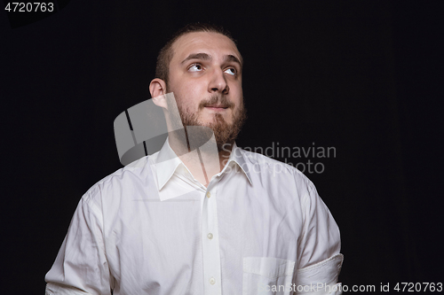 Image of Close up portrait of young man isolated on black studio background